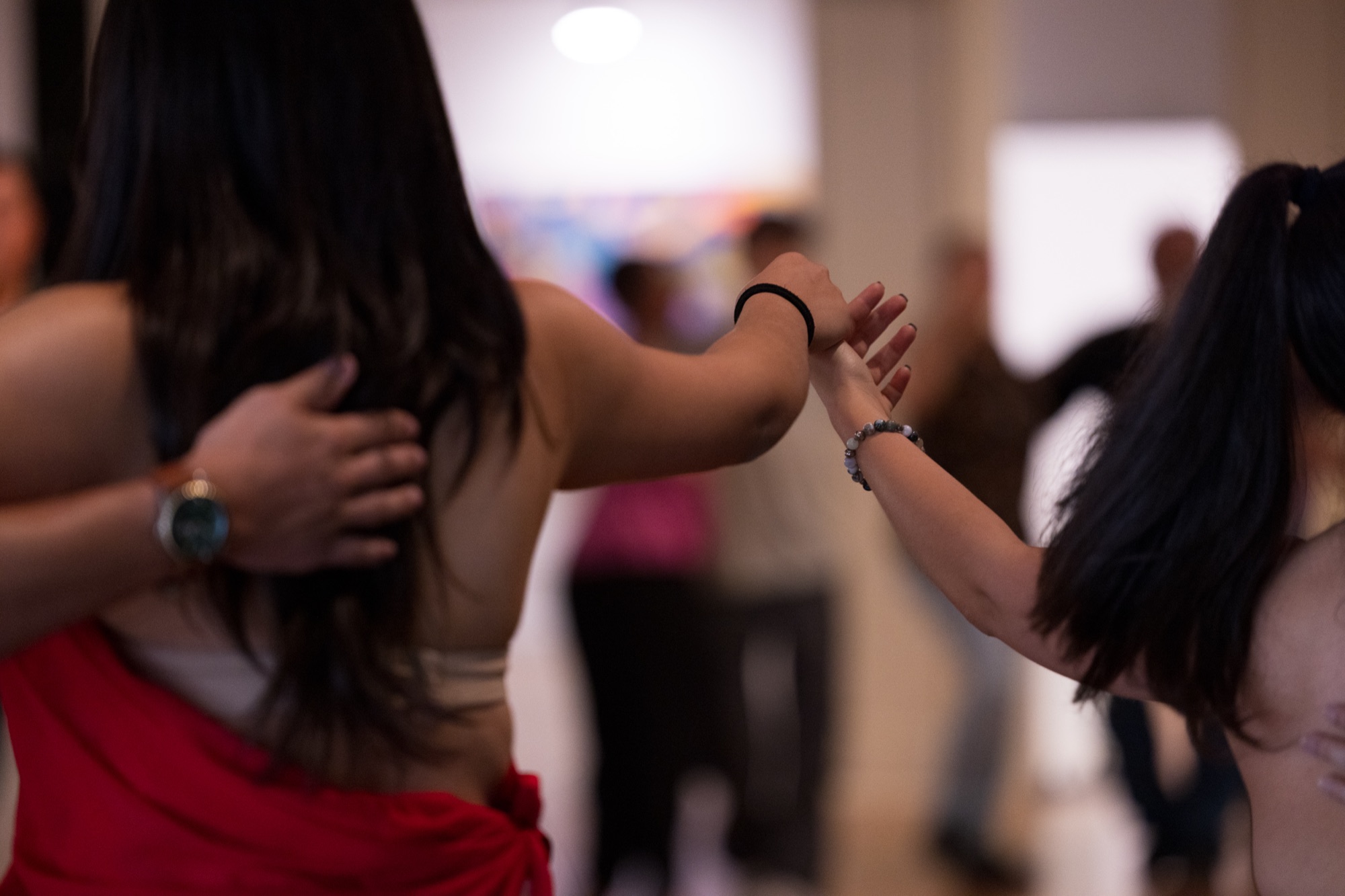Two dancers' hands almost touching