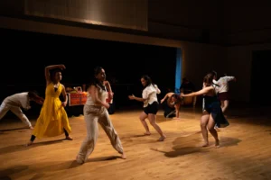 Ritwal — the ensemble mid-phrase, with the ofrenda table upstage, UC Riverside Department of Dance, Spring Forward 2023