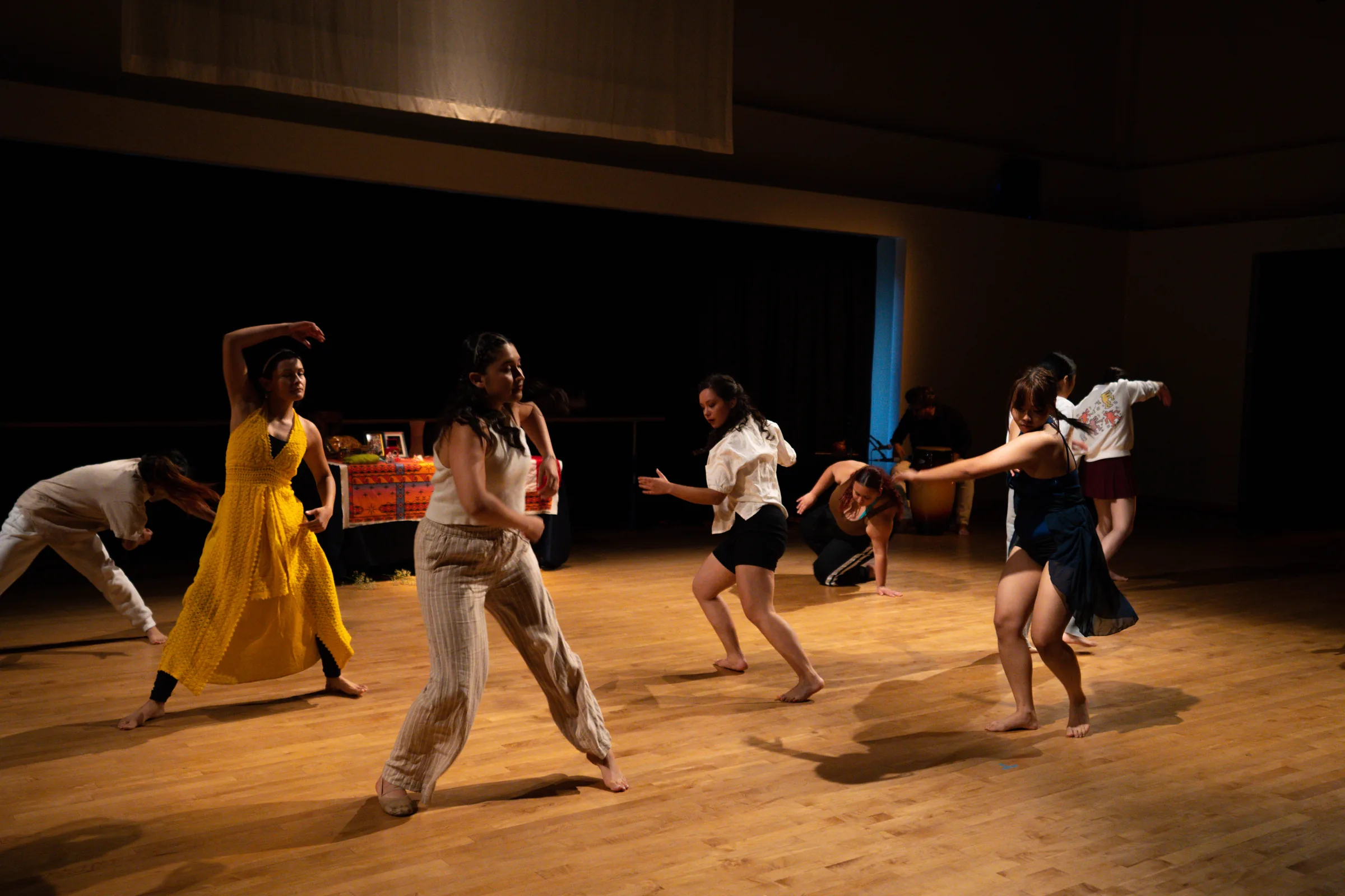 Ritwal — the ensemble mid-phrase, with the ofrenda table upstage, UC Riverside Department of Dance, Spring Forward 2023
